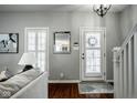 Bright entryway featuring hardwood floors, white trim, and a staircase leading to the upper level at 2067 Rhettsbury St, Carmel, IN 46032