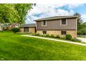 Charming home with manicured lawn, stone accents, and gray siding, offering great curb appeal at 224 Brierley Way, Carmel, IN 46032