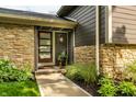 Modern front door with glass panels and stone accents, creating a welcoming entrance at 224 Brierley Way, Carmel, IN 46032