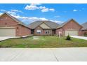 Beautiful lawn, new construction homes with brick exteriors and attached garages at 2753 Stones Bay Dr, Greenwood, IN 46143