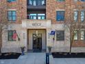 Entrance to a building with stone facade, flags, flower boxes and glass doors at 355 E Ohio St # 221, Indianapolis, IN 46204