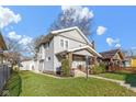 Two-story home with a well-maintained lawn and detached garage with white siding at 3960 N Park Ave, Indianapolis, IN 46205