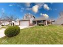 Charming two-story home with a well-manicured lawn, American flag, and mature landscaping at 628 Southridge Ct, Westfield, IN 46074