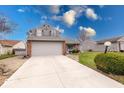 Charming two-story home featuring a two-car garage and well-manicured front lawn with mature landscaping at 628 Southridge Ct, Westfield, IN 46074