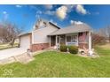 Charming two-story home with well-manicured lawn and beautifully landscaped yard and covered porch at 628 Southridge Ct, Westfield, IN 46074