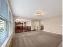 Bright living room with large windows, neutral decor, and an open concept layout at 643 Bracknell Dr, Avon, IN 46123