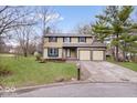 Traditional two-story home featuring an attached two-car garage and a well-maintained lawn at 6602 Boston Ridge Ct, Indianapolis, IN 46237