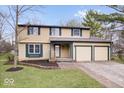 Traditional two-story home featuring an attached two-car garage and a well-maintained lawn at 6602 Boston Ridge Ct, Indianapolis, IN 46237