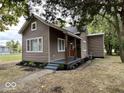 Charming home with neutral siding, a cozy front porch, and manicured landscaping at 709 S Vine St, Muncie, IN 47302