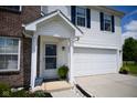 Close up of a well-kept front door with a storm door and a two car garage at 746 Greene Ct, Avon, IN 46123