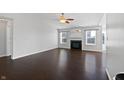 Bright living room with dark hardwood floors, fireplace, and many windows at 851 Pine Lake Dr, Greenwood, IN 46143