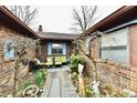 Charming brick courtyard with outdoor furniture and landscaping with seasonal decor at 9053 Sunset Ln, Brownsburg, IN 46112