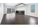 Open-concept living room with hardwood floors, modern fireplace, and lots of natural light at 917 Buchanan St, Indianapolis, IN 46203