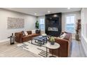 Modern living room features a fireplace, large windows, and comfortable seating at 9184 Anthem Ave, Plainfield, IN 46168