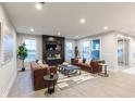 Modern living room features a fireplace, large windows, and comfortable seating at 9184 Anthem Ave, Plainfield, IN 46168
