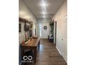 Inviting entryway with wood floors, decorative accents, and a view of the front door at 943 Rushmore Dr, Pittsboro, IN 46167