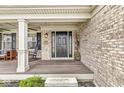 Welcoming front porch leading to an elegant black front door at 11789 Langham Crescent Ct, Fishers, IN 46037