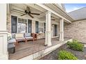Inviting front porch with comfortable seating, ceiling fans, and stylish columns at 11789 Langham Crescent Ct, Fishers, IN 46037