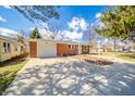 Well-maintained brick ranch with attached garage and a spacious driveway at 1219 Fairfax St, Anderson, IN 46012