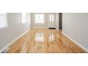 Inviting living room featuring pristine hardwood floors and fresh neutral paint at 1219 Fairfax St, Anderson, IN 46012