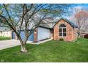 Charming two-story brick home with attached two car garage and a well-manicured front lawn at 12702 Slippery Rock Rd, Indianapolis, IN 46236