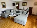 Comfortable living area with hardwood floors, a large sectional sofa, and stylish decor at 128 Mulberry Rd, Anderson, IN 46017