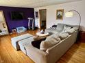 Spacious living room boasts hardwood floors, a sectional sofa, and a contemporary entertainment setup at 128 Mulberry Rd, Anderson, IN 46017