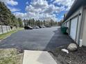 Parking lot area with multiple parked cars and several garages at 1711 Lafayette Ave # 5, Lebanon, IN 46052