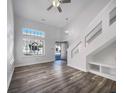 Bright living room with a ceiling fan, hardwood floors and a modern staircase at 2632 Frasier Fir Dr, Greenwood, IN 46143