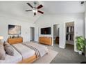 Spacious main bedroom featuring a ceiling fan, large bed, and ensuite bathroom at 2632 Frasier Fir Dr, Greenwood, IN 46143
