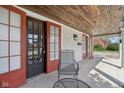 Spacious covered front porch with tiled flooring, outdoor seating, and wood ceiling at 304 W 43Rd St, Indianapolis, IN 46208