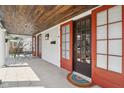 Covered front porch features a wood ceiling, tile flooring, and multiple entry doors at 304 W 43Rd St, Indianapolis, IN 46208