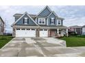Inviting blue two-story home featuring a three-car garage and well-maintained landscaping at 3164 Kent Dr, Brownsburg, IN 46112