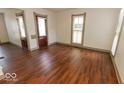 Spacious living room boasts rich wood floors and plenty of natural light from the windows at 325 E 10Th St, Indianapolis, IN 46202