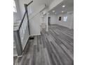 Spacious living area featuring sleek gray floors, recessed lighting, and an open layout to the kitchen at 3614 N Capitol Ave, Indianapolis, IN 46208