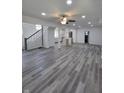 Bright, open-concept living space featuring modern gray flooring, fresh paint, and plenty of natural light at 3614 N Capitol Ave, Indianapolis, IN 46208