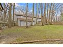 Expansive backyard with mature trees and a shed, perfect for outdoor activities at 4140 Melbourne Rd, Indianapolis, IN 46228
