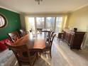 Dining room with large window, hardwood table, and chairs, providing a bright and comfortable dining space at 4140 Melbourne Rd, Indianapolis, IN 46228