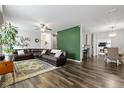 Spacious living room featuring a large sectional sofa, decorative rug, and hardwood floors at 4221 Millersville Rd, Indianapolis, IN 46205