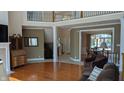 Spacious living room with hardwood floors, fireplace, and views into adjacent rooms at 452 Twin Oaks Dr, Carmel, IN 46032