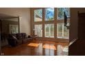Inviting living room features large windows, hardwood floors, and comfortable seating at 452 Twin Oaks Dr, Carmel, IN 46032