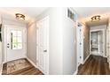 Bright and clean hallway with hardwood floors and access to other rooms at 4625 Berkshire Ln, Indianapolis, IN 46226