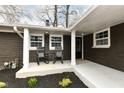 Welcoming front porch with rocking chairs and a freshly painted front door at 4625 Berkshire Ln, Indianapolis, IN 46226