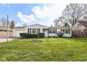 Charming single-story home with well-manicured lawn, inviting curb appeal, and attached garage at 5849 Brouse Ave, Indianapolis, IN 46220