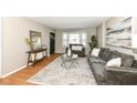 Comfortable living room featuring stylish gray sofas, decorative rug, and ample natural light at 5849 Brouse Ave, Indianapolis, IN 46220