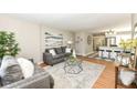 Open-concept living room connected to a modern kitchen with stainless steel appliances and island at 5849 Brouse Ave, Indianapolis, IN 46220