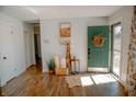 Bright foyer with wood flooring, a charming green front door, and stylish decor at 6315 S Keystone Ave, Indianapolis, IN 46227