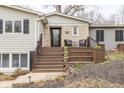 Inviting front porch with seating, leading to a charming home with curb appeal at 7806 Meadowbrook Dr, Indianapolis, IN 46240