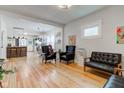 Open-concept living room with hardwood floors and seamless flow to the kitchen at 805 N Tuxedo St, Indianapolis, IN 46201