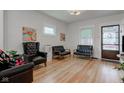 Cozy living room featuring refinished hardwood floors and ample seating at 805 N Tuxedo St, Indianapolis, IN 46201